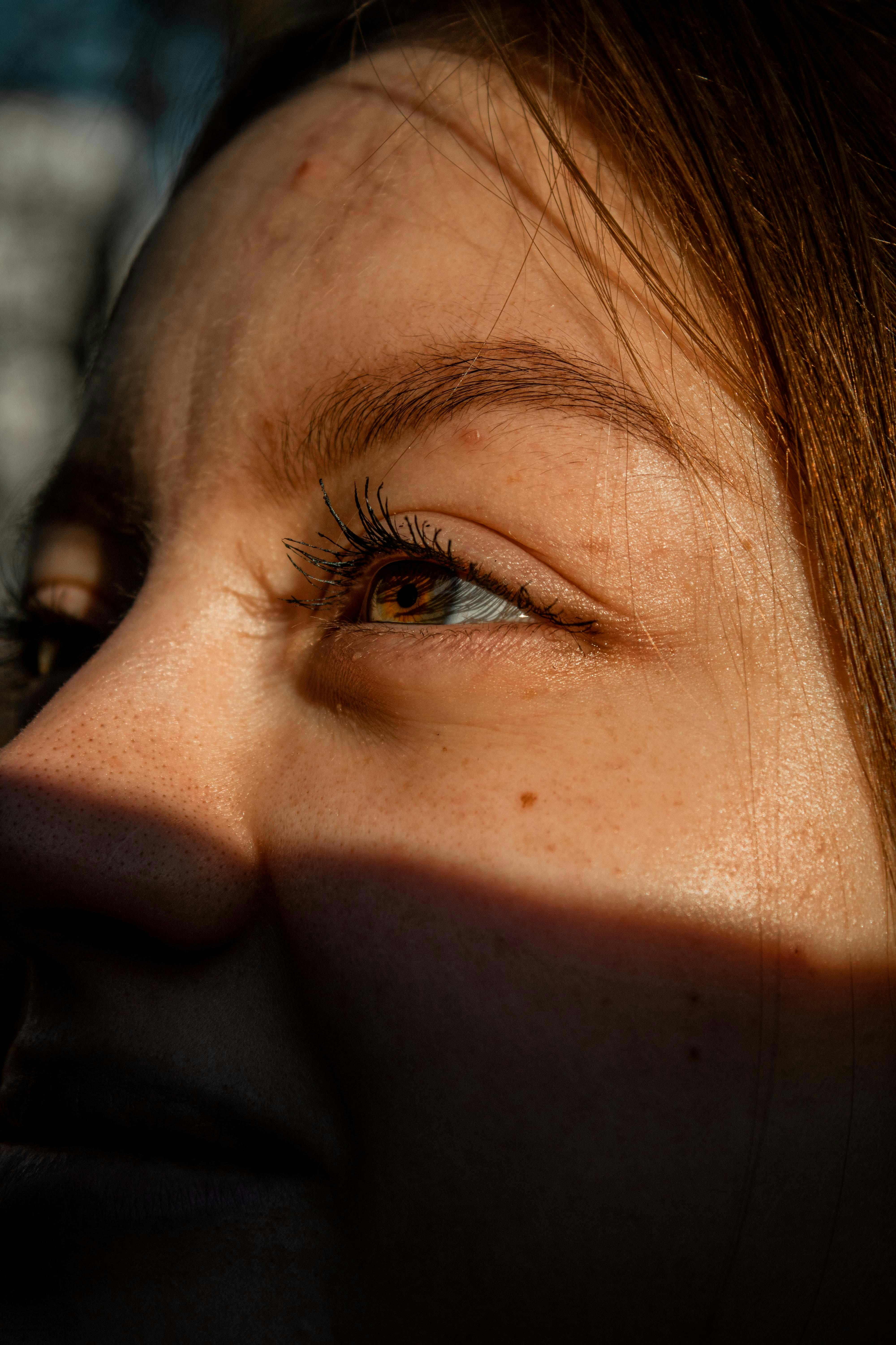 Bright outdoor sunlight, squinting in strong light